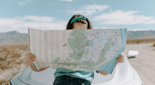 A woman examining a road map, or is it a B2B customer journey map? 